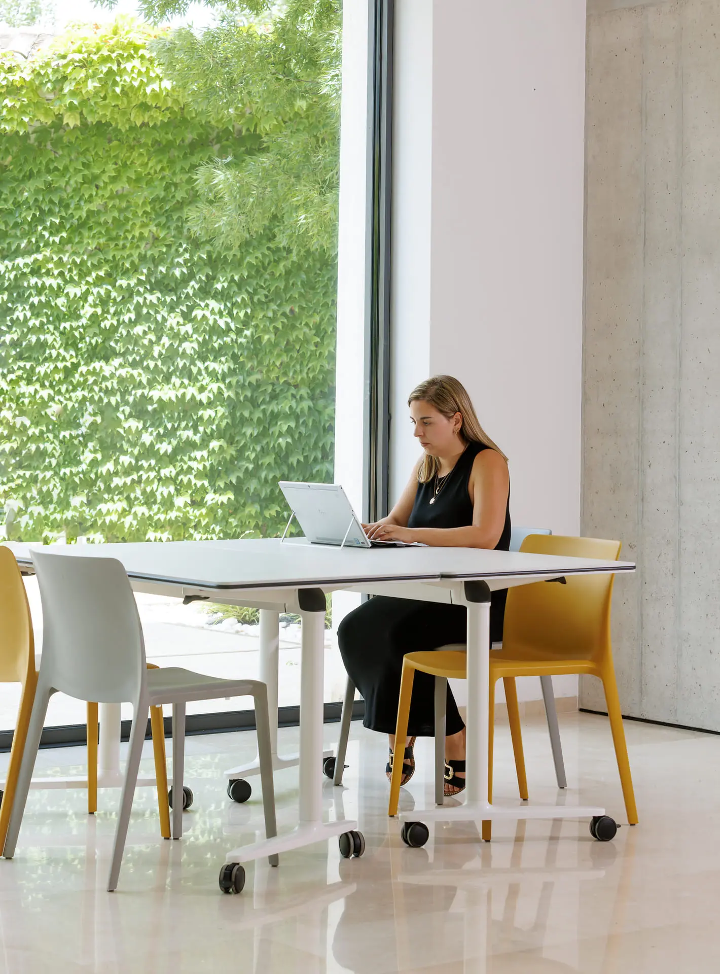 Mujer teletrabajando en mesa móvil